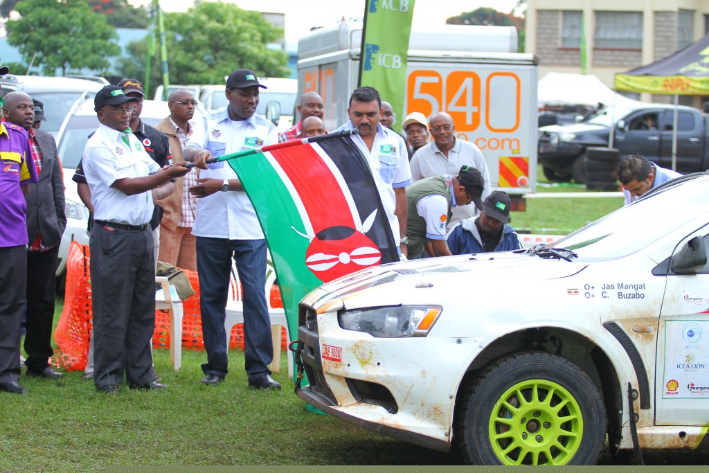 Ngeny Biwott, the KCB Chairman flaggs off Raaji Bharij navigated by Janeil Ghataure in a Mitsubishi Evo 10 during the 63rd KCB Safari rally at KICC